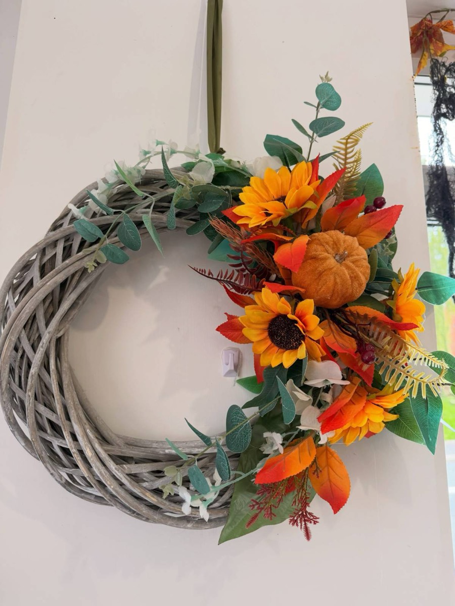 Autumn wreath with sunflowers and pumpkins
