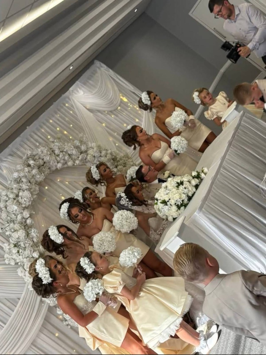 White wedding flower arrangement along a top table